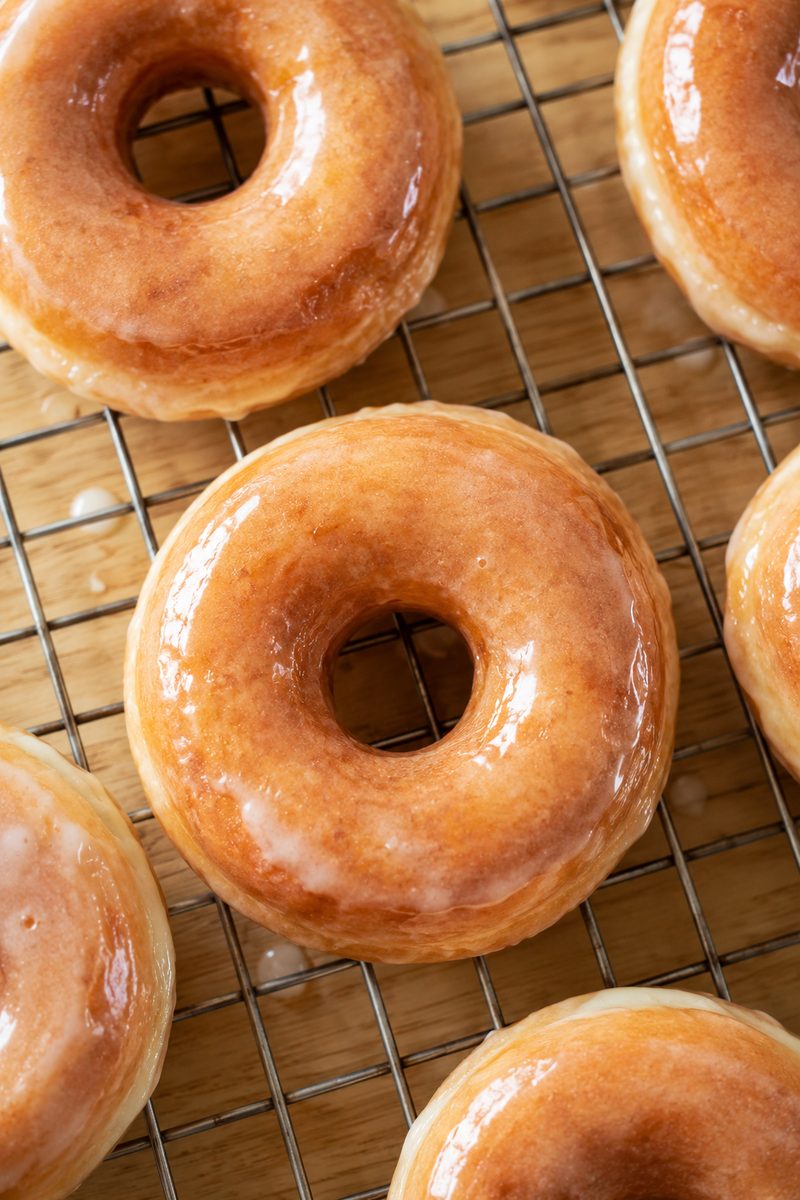 Golden glazed old-fashioned donuts cooling on a wire rack